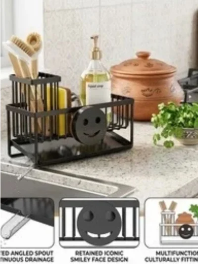 A black rust-proof kitchen sink organizer stand holding brushes and a smiley sponge, perfect for keeping your kitchen neat.