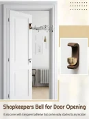 Black walnut shopkeeper entrance door bell mounted on white frame with easy adhesive setup.