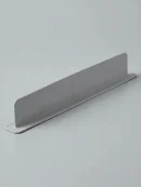 Grey flexible silicone water stopper for kitchen counter with a flat base and suction cups for easy setup.