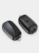 Close-up of a black compact solar mobile charger showing the solar panel and direct plug mini power pod connector.