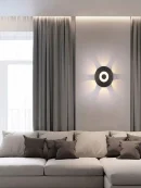 Black Aluminium Wall Sconce installed in a modern living room providing warm, 4000K Neutral White light.