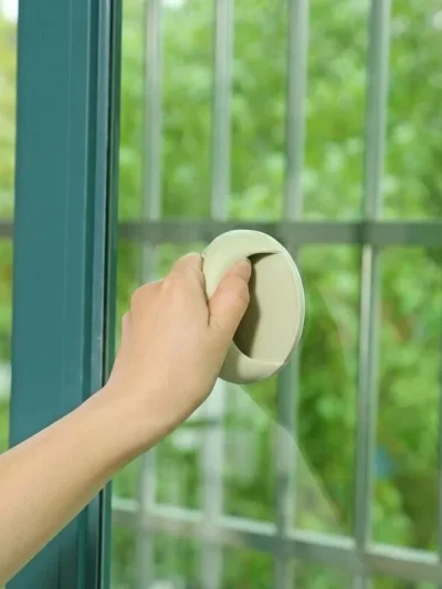 Glass door self stick auxiliary grip attached as a sliding window puller handle for easy opening.